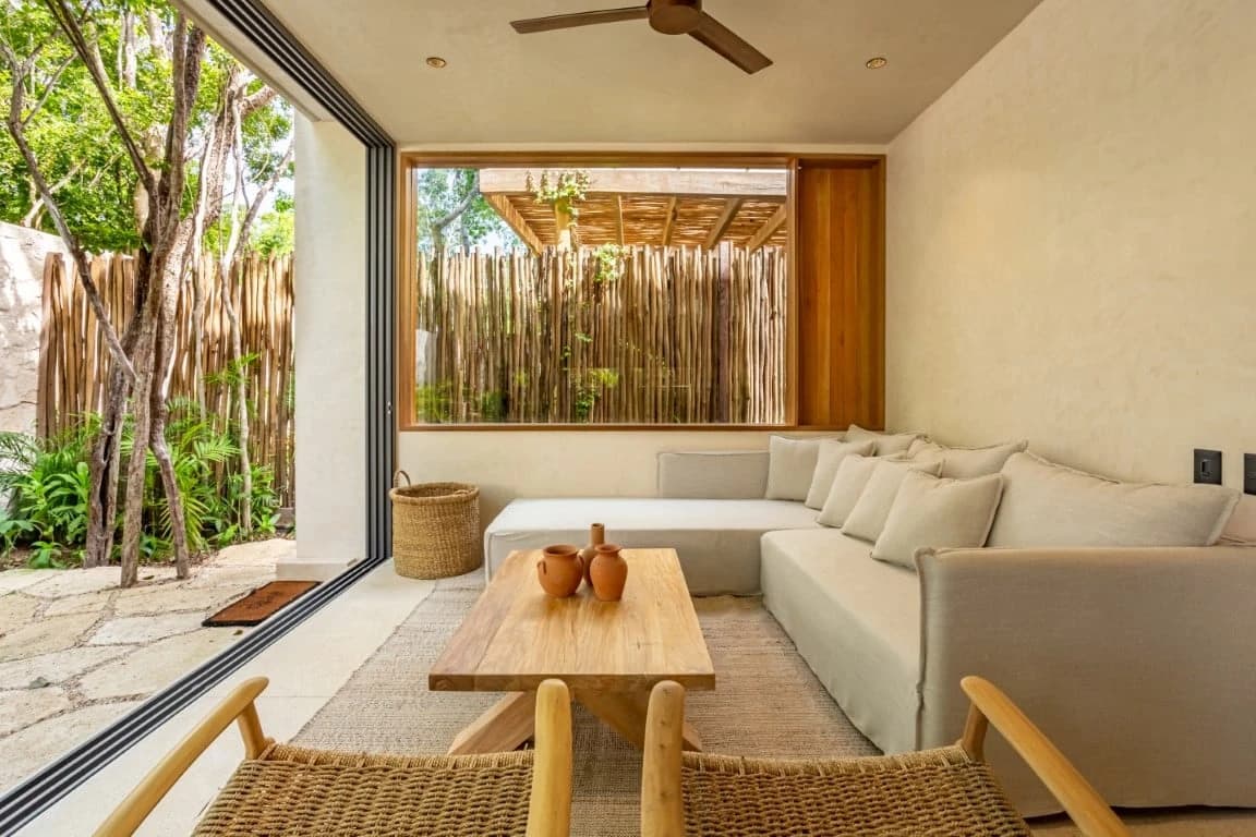 Amari Tulum covered outdoor lounge with warm plaster and wood detailing.