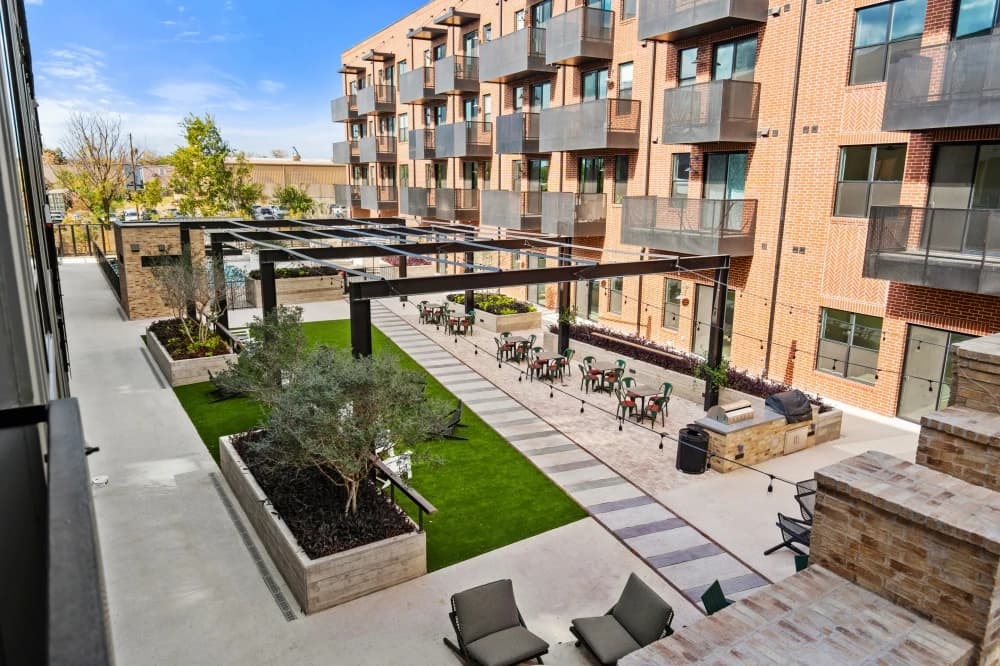Open-plan condominium living and dining room with balcony access.