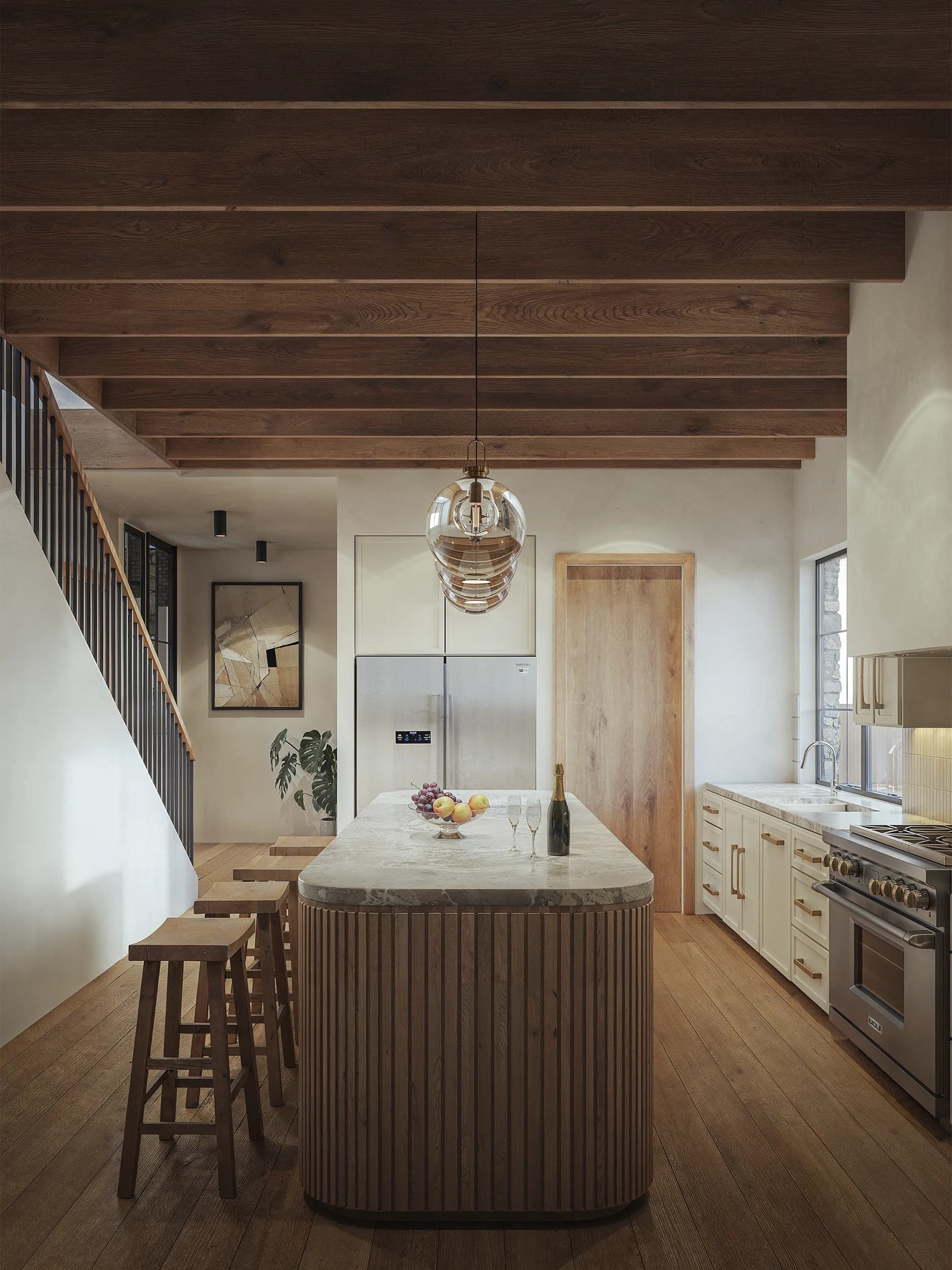 Emerald Forest chef's kitchen with an oversized island and warm cabinetry.